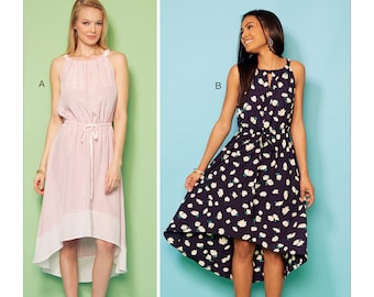 May include: Kwik Sew sewing pattern #K4206 for a high-low dress with a tie at the waist. The pattern shows two versions of the dress, one in pink with a white hem and one in black with a white floral print.