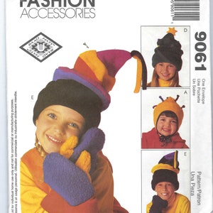 May include: A sewing pattern for making three different hats. The hats are a rainbow striped hat, a yellow and black bee hat, and a purple and black jester hat. The pattern is called "Baad Hats" and the pattern number is 9061.
