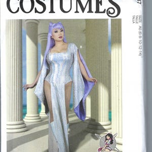 May include: McCall's Costumes sewing pattern for a silver and purple costume. The pattern is for sizes 6-8, 10-12, and 14. The pattern is for a costume with a long, flowing skirt and a bodice with a plunging neckline. The model is wearing a silver and purple costume with a long, flowing skirt and a bodice with a plunging neckline. The model is standing in front of a white background.