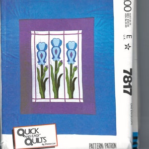 May include: A McCall's quilting pattern featuring a stained glass design with three blue irises on a white background. The pattern is titled "Quick and Easy Quilts" by Donna Lee. The pattern number is 7817.