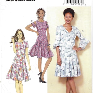 May include: A sewing pattern from Butterick, BP336, featuring illustrations of three different dress designs. The dresses have floral patterns and varying sleeve and neckline styles. The pattern size is A5, for sizes 6-8-10-12-14.