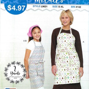 May include: Sewing pattern for two aprons, one with a pink and green diamond pattern and the other with a blue and white polka dot pattern. The pattern is from McCall's and is called "It's Sew Simple".