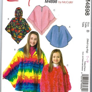 May include: A sewing pattern for ponchos, featuring various designs. The pattern includes a tie-dye poncho, a pink fringed poncho, a blue poncho, and a red fuzzy poncho. The text "Easy stitch'n save" and "M4898 by McCall's" are visible.