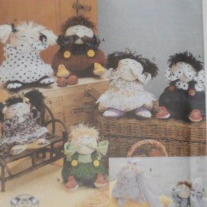 May include: A Simplicity crafts pattern for making six different dolls. The pattern is for one size and includes instructions for making a girl doll with a polka dot dress, a boy doll with a brown shirt and dungarees, a girl doll with a floral dress, a boy doll with a blue shirt and trousers, a boy doll with a green shirt and dungarees, and a girl doll with a blue dress.