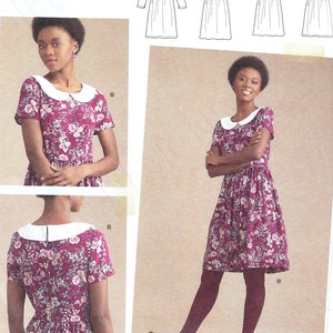 May include: Simplicity sewing pattern number S8946 R5 for a baby doll dress. The pattern includes four different dress styles with short sleeves, long sleeves, and a button-up front. The pattern is for sizes US 14-22, EU 40-48, and FR 42-50.