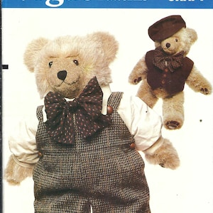 May include: Vogue Patterns craft pattern featuring a teddy bear wearing a tweed overall and a large bow tie. The pattern includes instructions for a second bear wearing a beret and vest. The Vogue Patterns logo is visible.