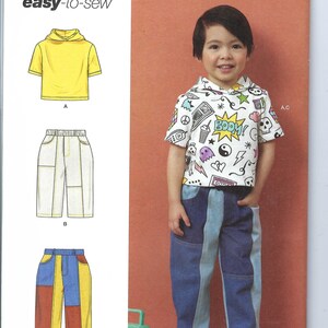 Può includere: Un cartamodello per abbigliamento per bambini, Simplicity modello numero R12145, include istruzioni per una maglietta con cappuccio e pantaloni. Il cartamodello è per le taglie 1/2-4.