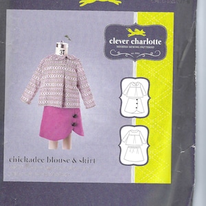 May include: A sewing pattern for a girl's blouse and skirt, called "chickadee blouse & skirt". The pattern is from "clever charlotte" modern sewing patterns. The pattern is for sizes 2T-8. The pattern shows a girl wearing a pink skirt and a patterned blouse.