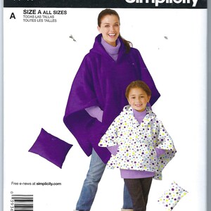 May include: Simplicity sewing pattern number 1747 for a hooded poncho. The pattern includes instructions for making a purple poncho and a white poncho with colorful polka dots. The pattern is available in all sizes.