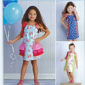 May include: A sewing pattern for a girls' summer dress. The pattern includes three different styles: a blue and white floral dress with a pink ruffle, a blue and white striped dress with a red ruffle, and a green and white floral dress with a pink ruffle. The pattern is called "Simplicity Summer Fun" and the pattern number is S0403.