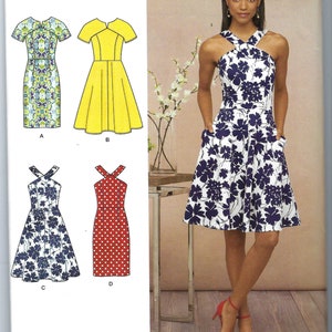 May include: A sewing pattern for a dress with four different variations. The pattern is for sizes US 14-22. The dress is shown in four different fabrics: a floral print, a solid yellow, a floral print, and a red polka dot.