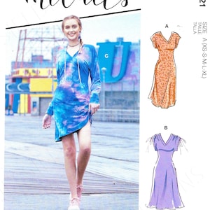 May include: McCall's sewing pattern R10621 features multiple dress designs. The image shows a woman wearing a tie-dye dress, and illustrations of two other dress styles. The pattern includes sizes XS-XL.