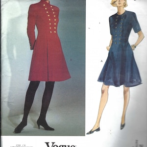 May include: Vogue Patterns American Designer sewing pattern with two dress designs. One is a red, long-sleeved coat dress with gold buttons. The other is a blue, short-sleeved dress with gold buttons. The pattern number is 2782 / 8.