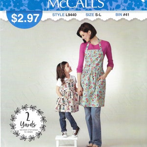 May include: A sewing pattern for two aprons, one for an adult and one for a child. The pattern is from McCall's and is called "It's Sew Simple". The pattern is for sizes S-L and requires 2 yards of fabric. The pattern is made in the USA.