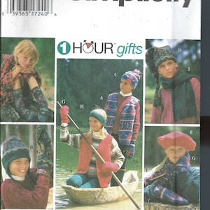 May include: A Simplicity sewing pattern for children's winter clothing. The pattern includes instructions for making a hat, scarf, and mittens. The pattern is for sizes S, M, and L. The pattern is titled "1 HOUR gifts".