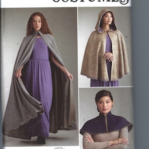 May include: Simplicity Costumes sewing pattern featuring three cape designs. The main image shows a woman wearing a gray cape over a purple dress. Other images show capes with hoods and high collars. The pattern is easy-to-sew.