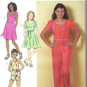 May include: Butterick sewing pattern B6888 for girls' clothing. The pattern includes designs for a pink dress, a green gingham dress, a striped jumpsuit, and a romper with a fruit print. Sizes A (7-8-10-12-14).