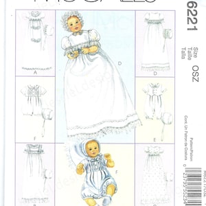 May include: A McCall's sewing pattern featuring illustrations of baby clothing, including dresses, a romper, and bonnets. The pattern includes the text "Express Yourself" and the number M6221.