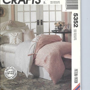 May include: A sewing pattern for a bed skirt and pillow shams. The pattern is for McCall's Crafts and is number 5352. The pattern shows a bed with a pink bed skirt and white pillow shams.