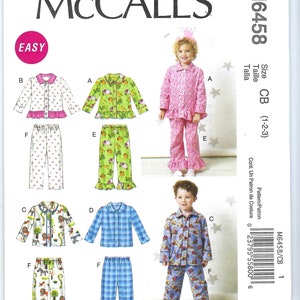 May include: Sewing pattern for children's pajamas. The pattern includes a variety of styles, including a pink and white floral print, a green and white animal print, a blue and white plaid print, and a blue and white truck print. The pattern is labeled "M6458/CB 1" and is for sizes 1-2-3.