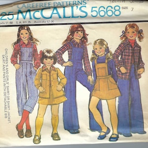 May include: A vintage sewing pattern for children's clothing. The pattern is for a shirt or shirt jacket, skirt, and pants with a detachable bib. The pattern is McCall's 5668, size 7.