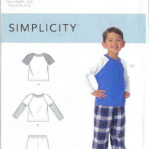 May include: A sewing pattern for a boy's pajama set. The pattern includes a short-sleeved t-shirt with a contrasting color raglan sleeve, a long-sleeved t-shirt with contrasting color raglan sleeves, and a pair of pajama pants. The pattern is for sizes 3-8. The pattern is from Simplicity.
