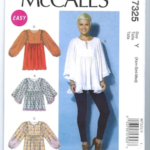 May include: A sewing pattern for a women's blouse with three different styles. The pattern is called McCall's M7325 and is for sizes X-Small, Small, and Medium. The blouse has a gathered neckline and long sleeves.