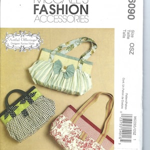 May include: Three different fabric handbags with various patterns and colours. The handbags have different styles of handles. The handbags are on a white background. McCall's Fashion Accessories. Artful Offerings. Designer Karina Hittle.