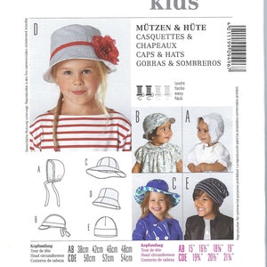 May include: A Burda Kids sewing pattern featuring various children's hat designs. The image shows a girl wearing a striped hat with a red flower. Measurements are provided in inches for head circumference.