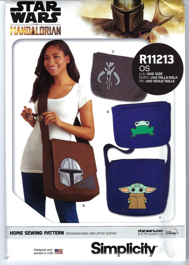 May include: A sewing pattern for messenger bags and laptop sleeves featuring characters from the Star Wars: The Mandalorian TV series. The pattern includes a blue bag with a green frog, a blue bag with a character from the show, a brown bag with a character from the show, and a gray bag with a symbol from the show. The pattern is labeled "R11213 OS" and includes the text "starwars.com &copy; & TM Lucasfilm Ltd. Disney+"