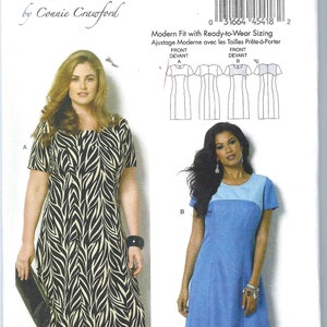 May include: Sewing pattern for a dress with two different styles. The first style is a zebra print dress with short sleeves. The second style is a blue dress with a white panel at the top and short sleeves. The pattern is for sizes X-Small to X-Large.
