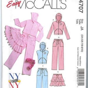 May include: Sewing pattern for a girl's outfit. The pattern includes a pink hooded top, pink pants, a blue sleeveless top, blue pants, a pink skirt with ruffles, and a pink skirt with ruffles. The pattern is for sizes 3/4 to 9/10. The pattern number is M4707.