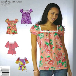 May include: Simplicity sewing pattern 2646 featuring various blouse designs. The pattern includes sizes 10-20. The image shows a woman wearing a floral print blouse with a square neckline and white trim. The pattern also includes other blouse styles.