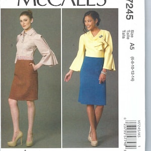 Puede incluir: Patrón de costura McCall's M7245 talla A5 (6-8-10-12-14) para una blusa y una falda. El patrón muestra dos estilos diferentes de blusas con una falda. Una blusa es una blusa amarilla con un escote con volantes y la otra es una blusa a rayas blancas y marrones con cuello. La falda es de color azul sólido.