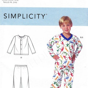 May include: Simplicity pattern R10705 for children's pajamas. The pattern includes a long-sleeved top and pants, with a child wearing a pajama set featuring a colorful lizard print. The pattern size is U.S. (3-8).