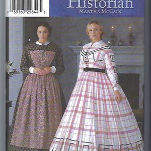 May include: Simplicity sewing pattern for The Fashion Historian by Martha McCain. The pattern features two women in historical dresses. The pattern includes sizes 6, 8, 10, and 12. The pattern number is 7212.