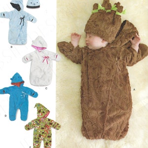 May include: Simplicity pattern 8030 features baby sleep sacks and hooded outfits. The image shows a baby in a brown, textured, hooded outfit with green accents. Other options include blue, white, and patterned sleep sacks.