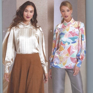 May include: Vogue Patterns sewing pattern featuring two blouse designs. One blouse is a cream-colored satin with a pleated front and long sleeves. The other is a colorful abstract print blouse with long sleeves. The pattern is labeled V1985.