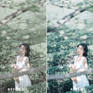 May include: A woman with long dark hair is standing in a field of green plants. She is wearing a white dress and has her eyes closed. She is holding a brown woven bag in her hands.