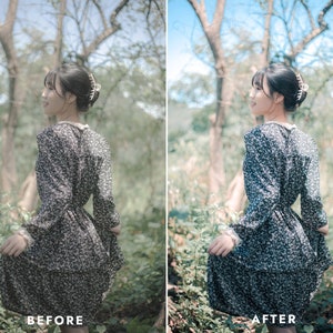 May include: A woman wearing a black and white floral dress with a white collar stands in a forest setting. The dress has a fitted bodice and a flowing skirt. The woman is looking to the right of the frame.