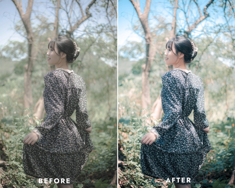 May include: A woman wearing a black and white floral dress with a white collar stands in a forest setting. The dress has a fitted bodice and a flowing skirt. The woman is looking to the right of the frame.