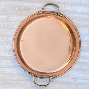 May include: A set of three ceramic mugs with a speckled, matte finish. The mugs are in shades of cream, light gray, and dark gray. Each mug has a simple, modern design and a rounded handle.