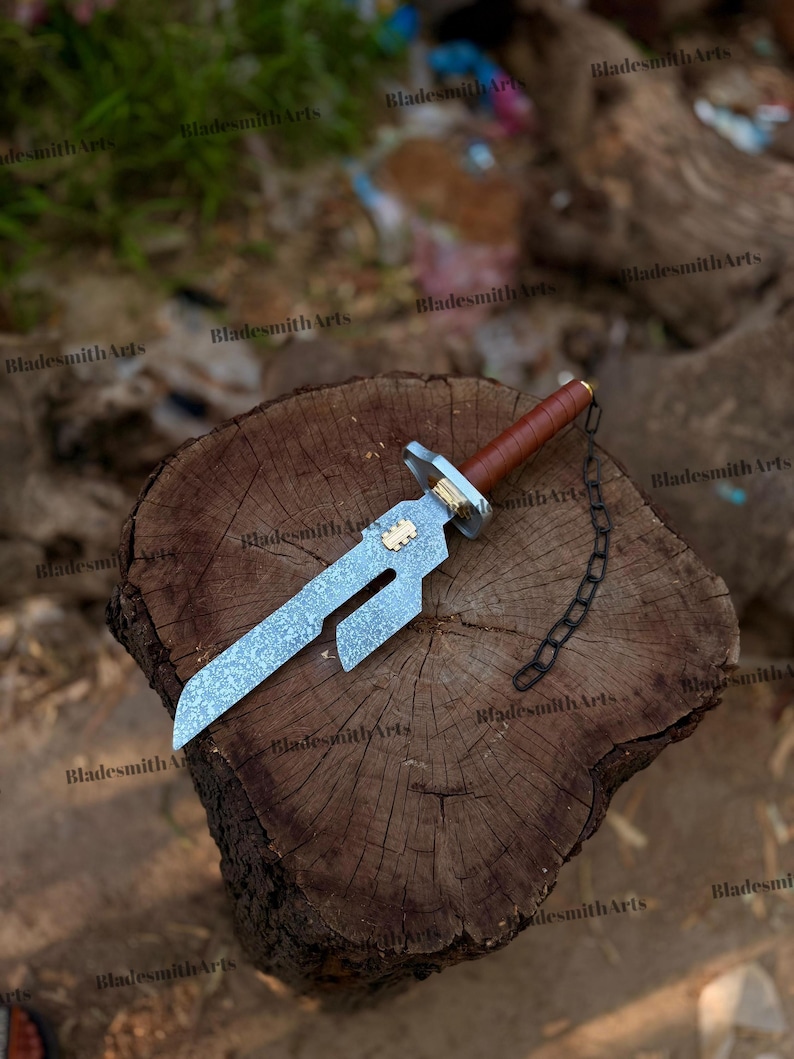 May include: A short sword with a textured silver-toned blade featuring a rectangular cutout, a brown leather-wrapped handle, a gold-toned accent piece, and a black metal chain attached to the pommel. The blade has a distinct angular design.