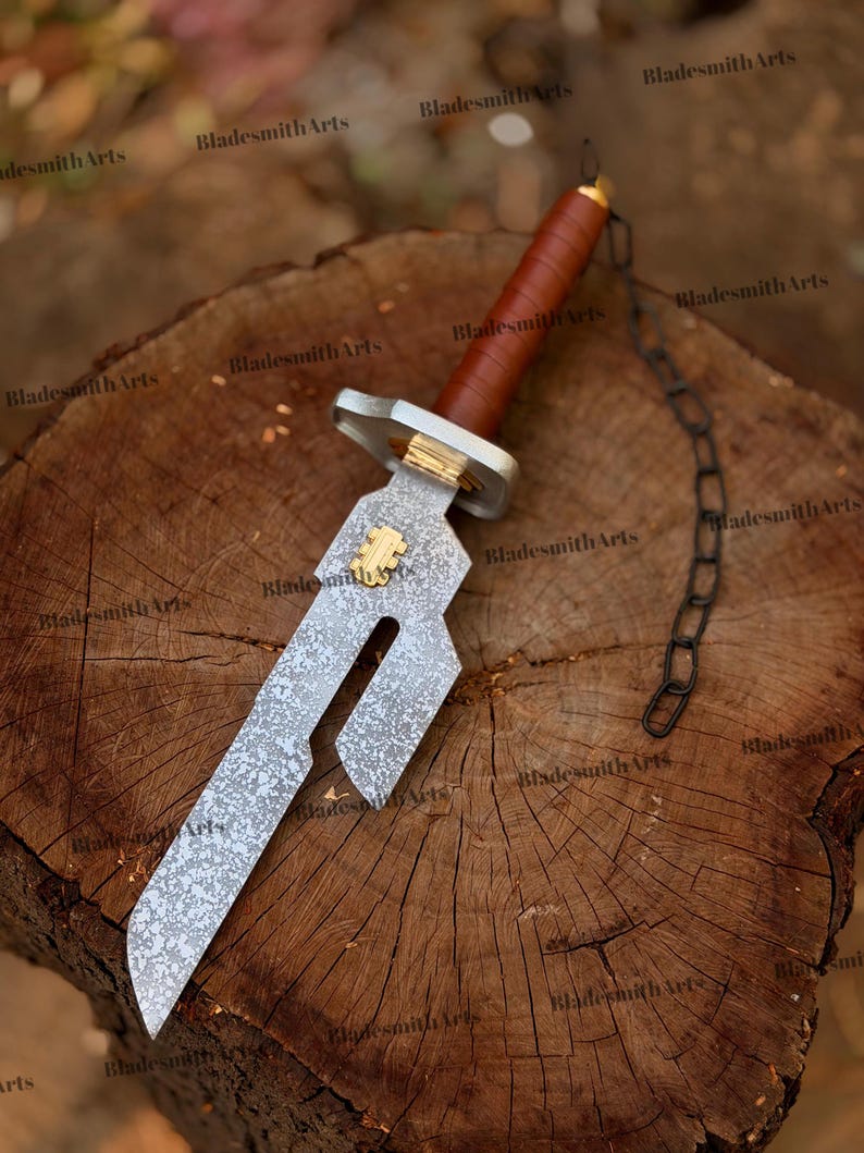 May include: A short sword with a mottled silver-toned blade featuring a rectangular cutout and a gold-colored emblem. The handle is wrapped in brown leather with a silver-toned guard and a black metal chain attached to the pommel.
