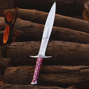 May include: A silver-colored metal dagger featuring a pointed blade with an etched swirling design and a crossguard. The handle is a deep red color with a silver-colored spiral pattern wrapping around it, ending in a flared, rounded pommel base.