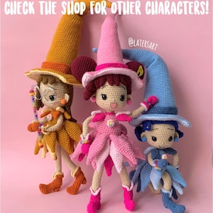 May include: Three handmade crochet dolls wearing pointed hats in mustard yellow, pink, and light blue. Each doll features a unique outfit with layered petal-like skirts and matching boots. The text "CHECK THE SHOP FOR OTHER CHARACTERS!" is visible.