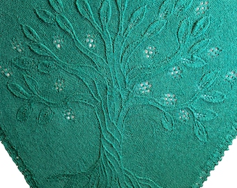 May include: A square emerald green textile featuring an embroidered tree motif. The tree has detailed leaves and small flower accents. The fabric has a textured appearance, and the edges are finished with a decorative border. The design is centered on the textile.