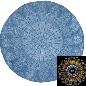 May include: A blue circular knitted throw blanket with a white floral pattern. The blanket has a circular design that resembles a stained glass window.