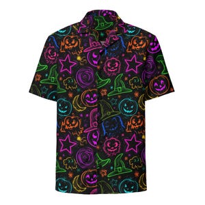 May include: A short-sleeve button-down shirt with a black background featuring a neon-colored pattern of jack-o'-lanterns, witch hats, stars, and swirling circular shapes in vibrant shades of green, orange, pink, purple, and blue.