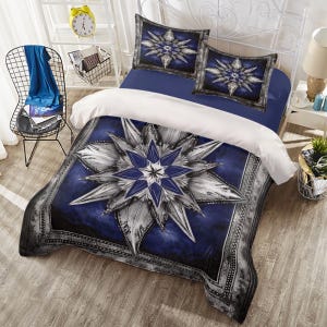 May include: Blue and white bedding set with a large, silver mandala design. The bedding set includes a duvet cover, two pillowcases, and a decorative throw pillow.